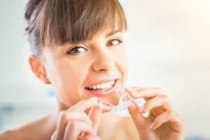 smiling woman with invisalign beckermeyer dds dentist niles mi